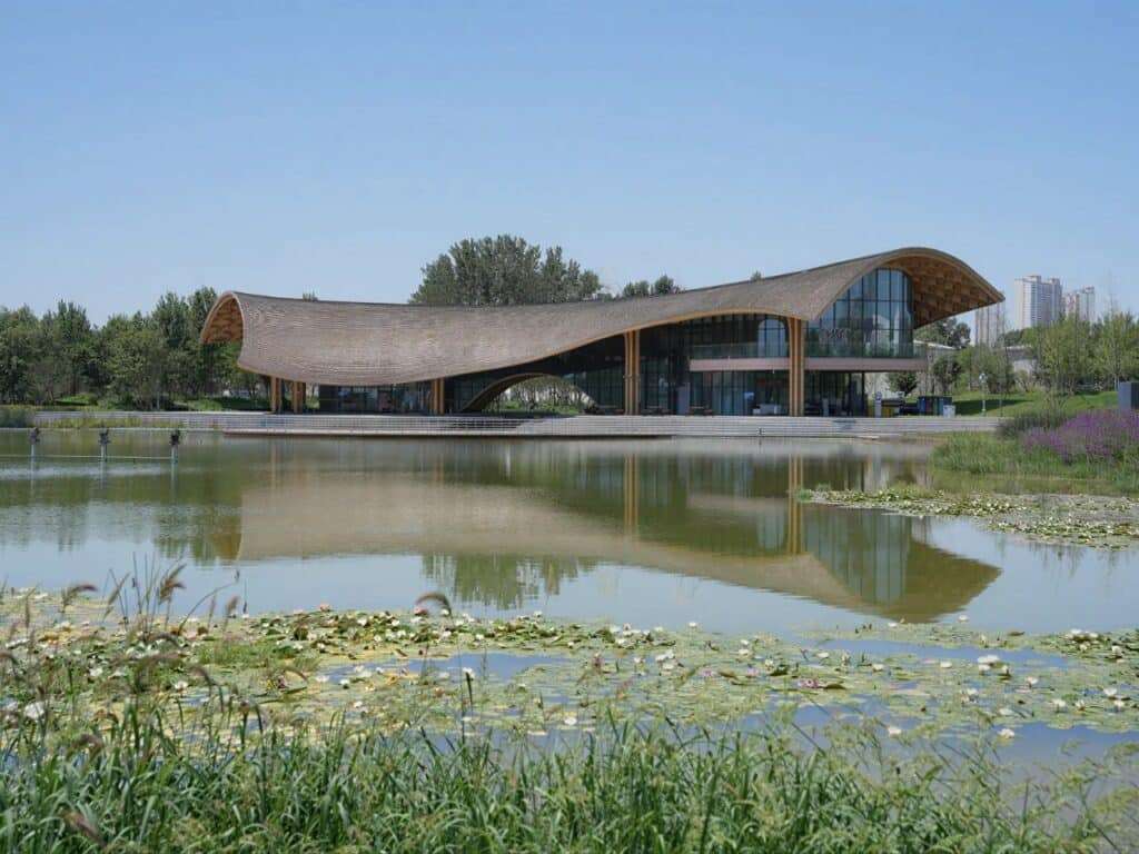 Distant view of the Silk Road restaurant across the lake with water lilies in the foreground.