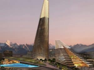 A wide exterior render of the Alatau Iconic Complex in Kazakhstan featuring two wedge-shaped skyscrapers inspired by the Trans-Ili Alatau mountains.