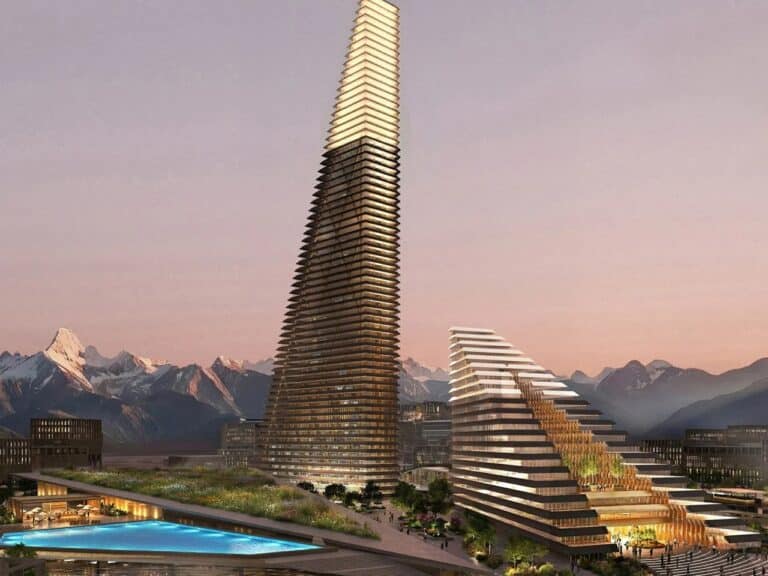 A wide exterior render of the Alatau Iconic Complex in Kazakhstan featuring two wedge-shaped skyscrapers inspired by the Trans-Ili Alatau mountains.