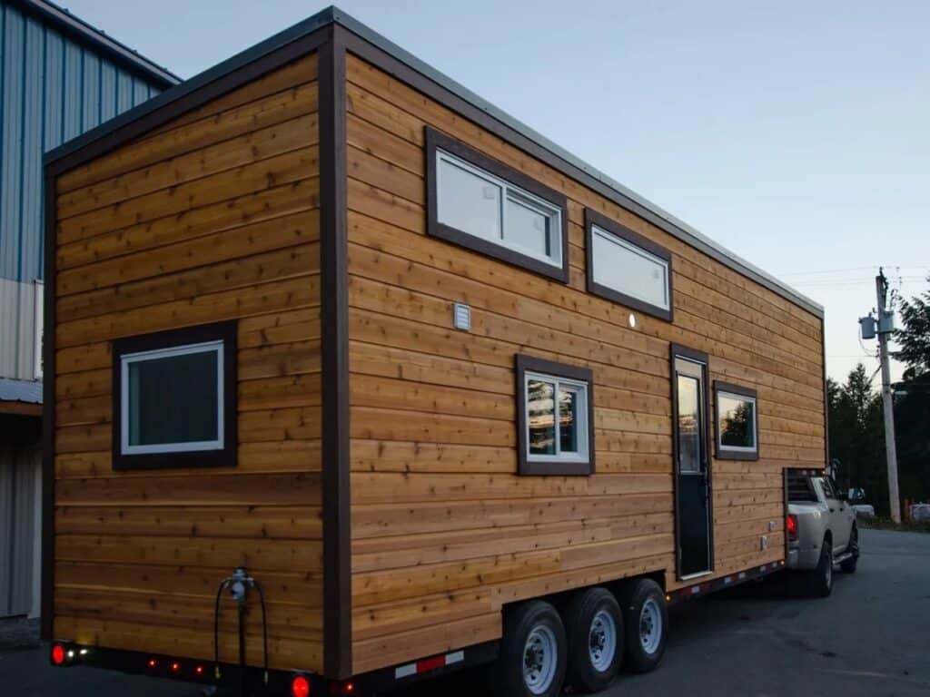 Perspective view of the Starling tiny house on wheels showing the entrance and vertical height.