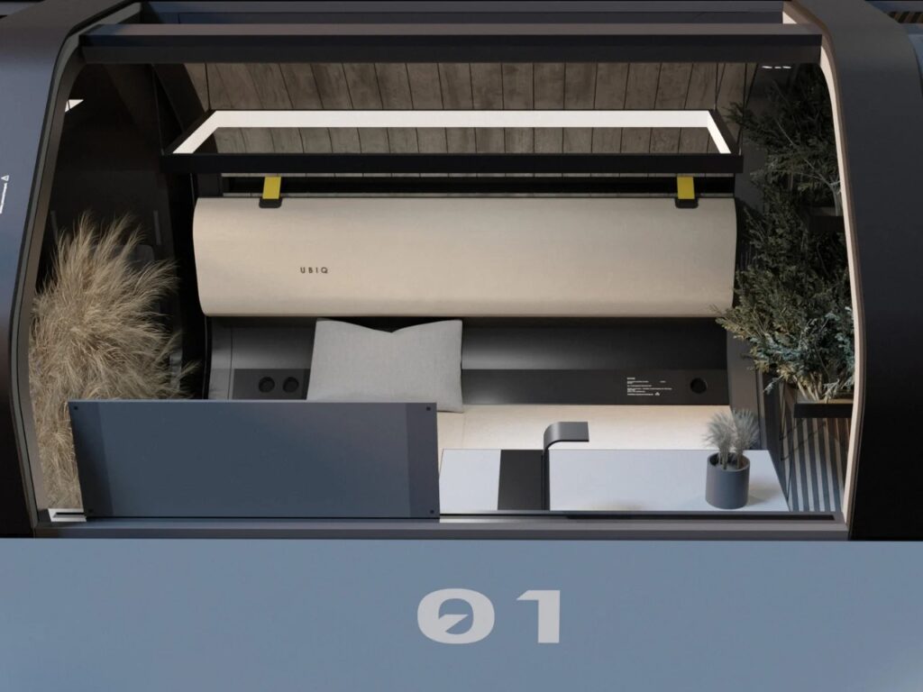 Functional interior of HYTTE cabin with integrated shelving, plants, and a minimalist work surface.