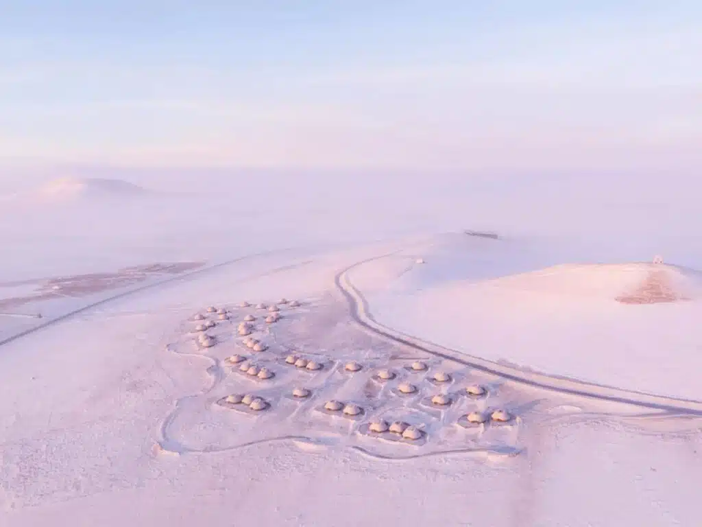 Wide aerial landscape showing the distributed layout of the Volcano-In project in the vast snowy Ulan Hada steppe.
