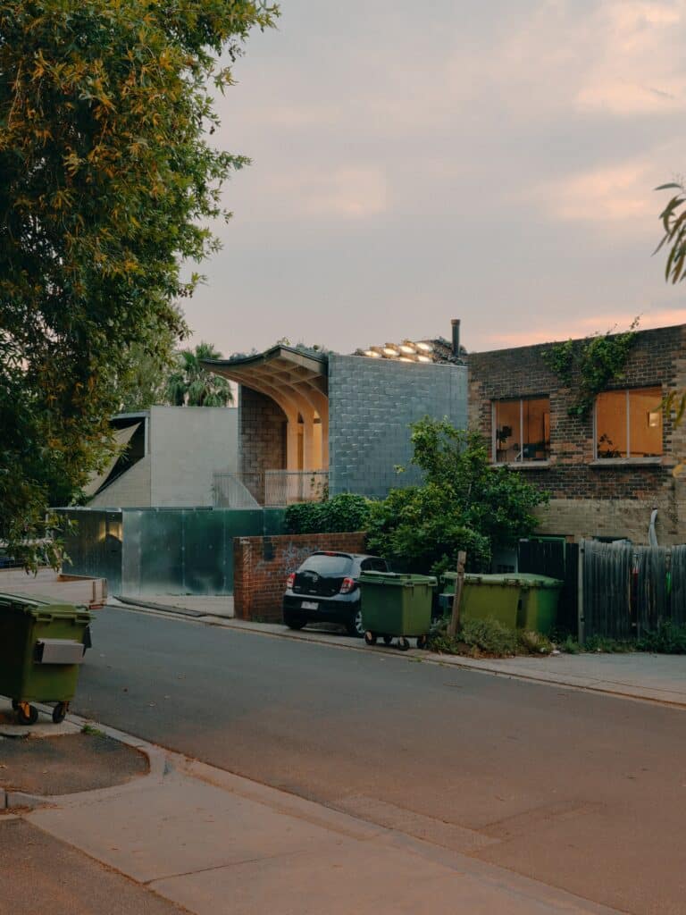 Northcote House by LLDS nestled within a narrow Melbourne street context next to traditional brick buildings.