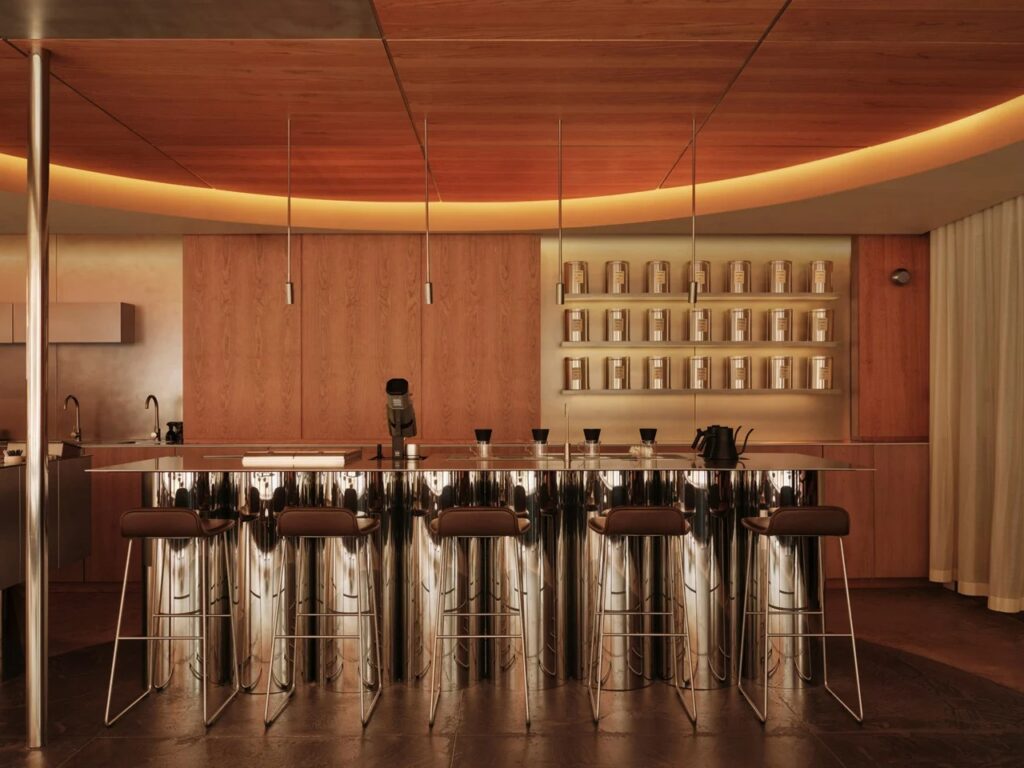 Mirrored chrome coffee bar under a circular illuminated ceiling at WatchHouse.