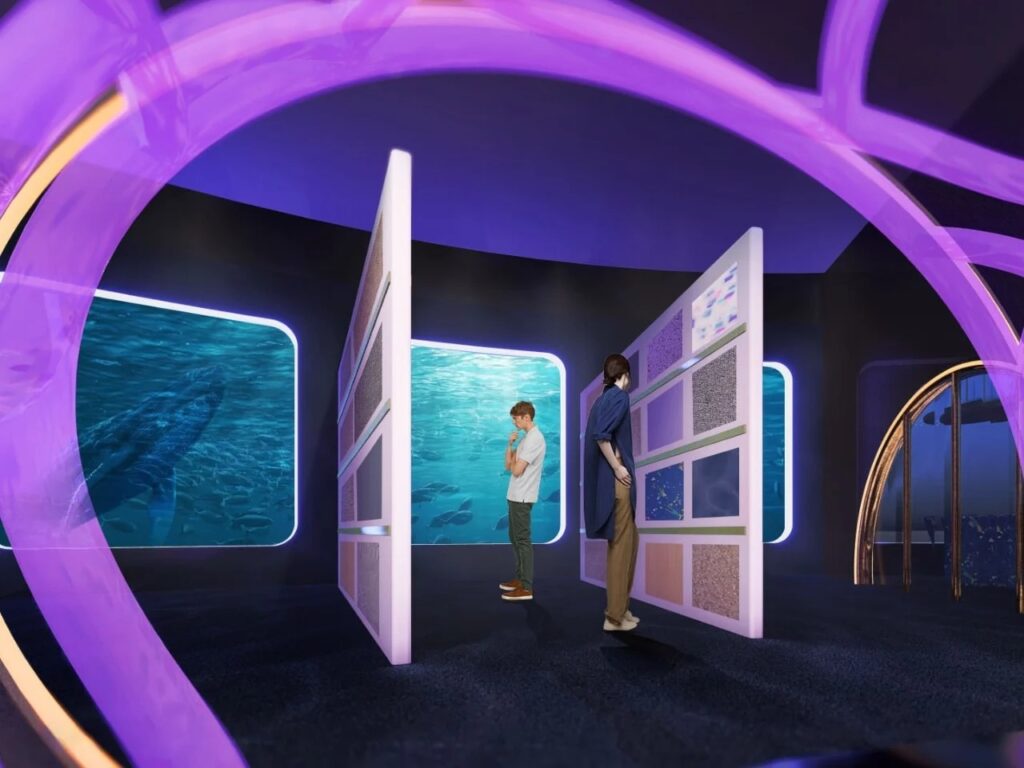 Minimalist interior space with glowing rectangular windows showing underwater coral reefs and blue water.