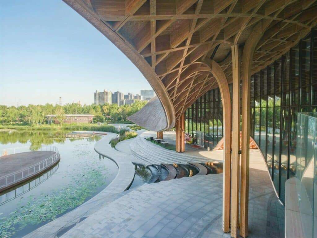 Elevated view of the restaurant&rsquo;s outdoor terrace, stone steps, and winding lakeside pathways.
