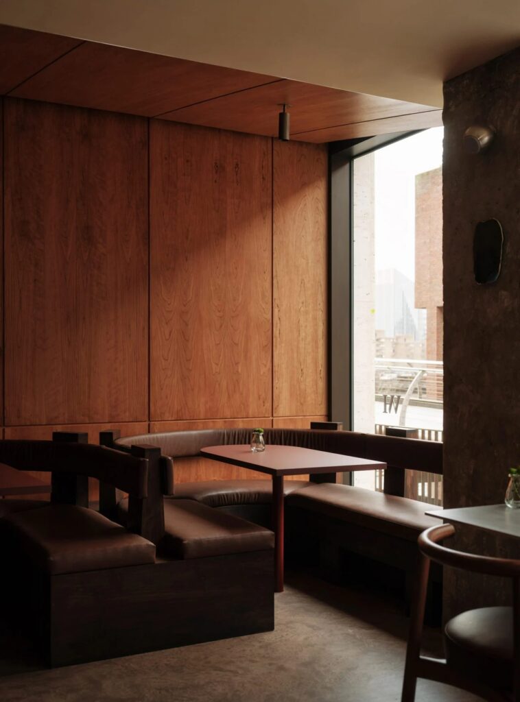 Leather booth seating next to a window overlooking the Thames at WatchHouse cafe.