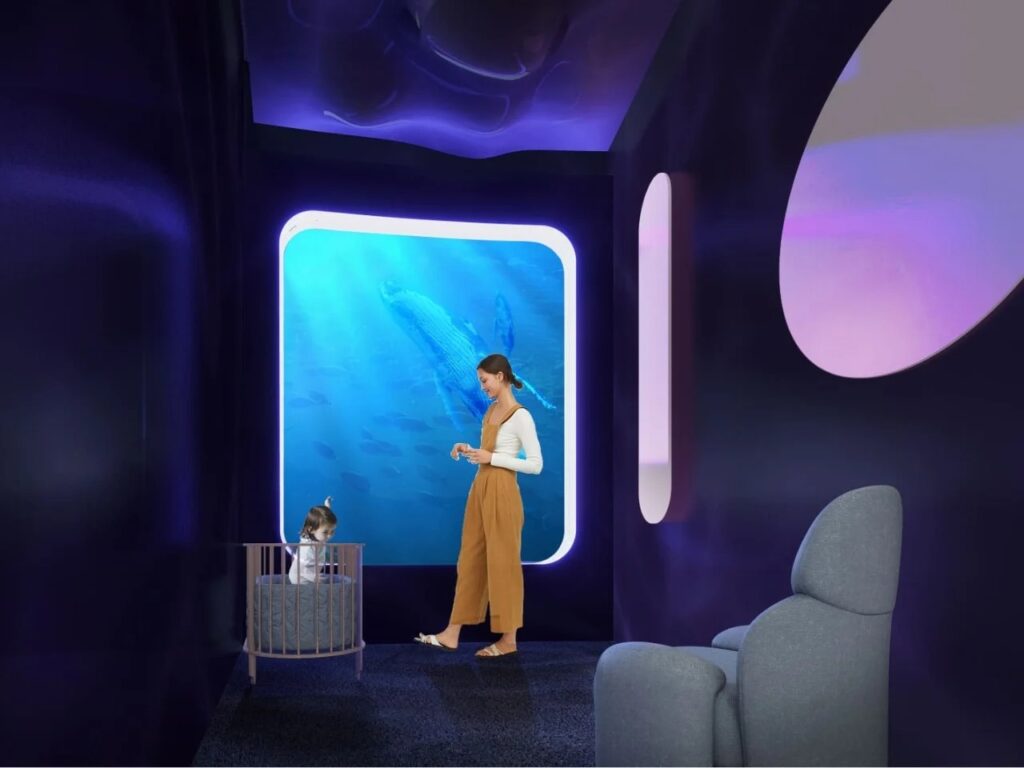 Serene private room with a mother and child next to a large circular window with blue ocean views.