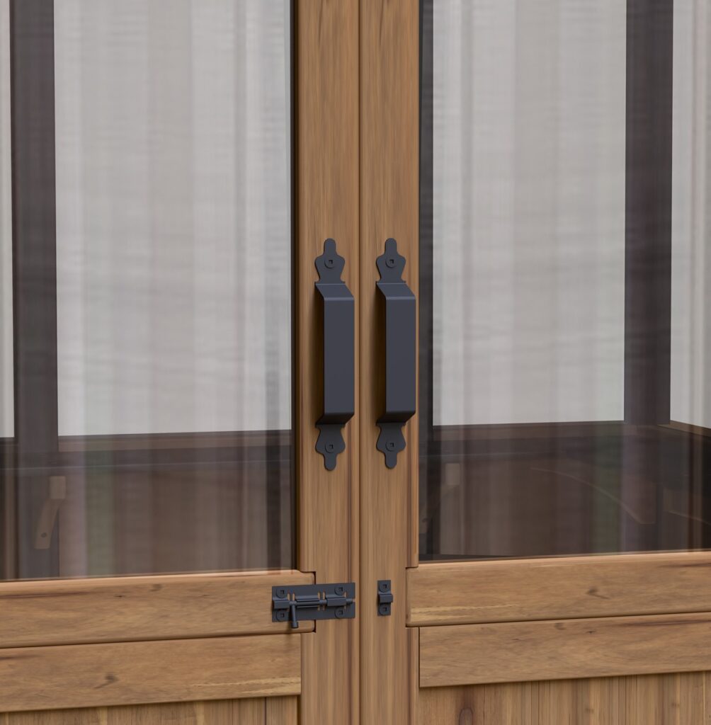 Detailed view of black metal handles and a sliding bolt latch on the wooden greenhouse doors.