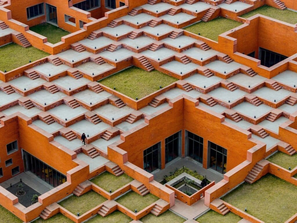 Top-down view of the courtyard and stepped roof integration at Prestige University.