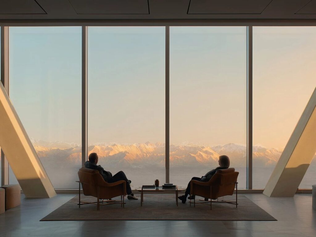 Interior view from a high-floor office in the Alatau Iconic Complex looking out through large windows at the snow-capped Alatau mountains.