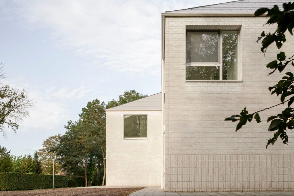 Close-up of the rear facade of Care Villa showing the repetition of pitched roof gables that represent individual living units.