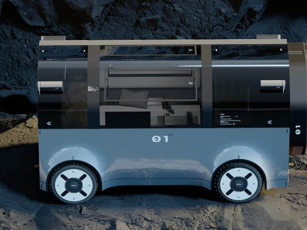 Side profile of the HYTTE mobile home showing the sleek blue body, wheels, and window arrangement.