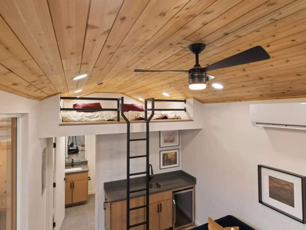 High-angle view of the Sledhaus 200 interior showing the wood ceiling fan and the loft beds.