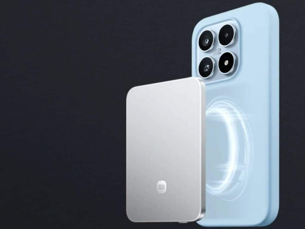 A silver power bank aligning with the magnetic rings on the back of a light blue smartphone case.