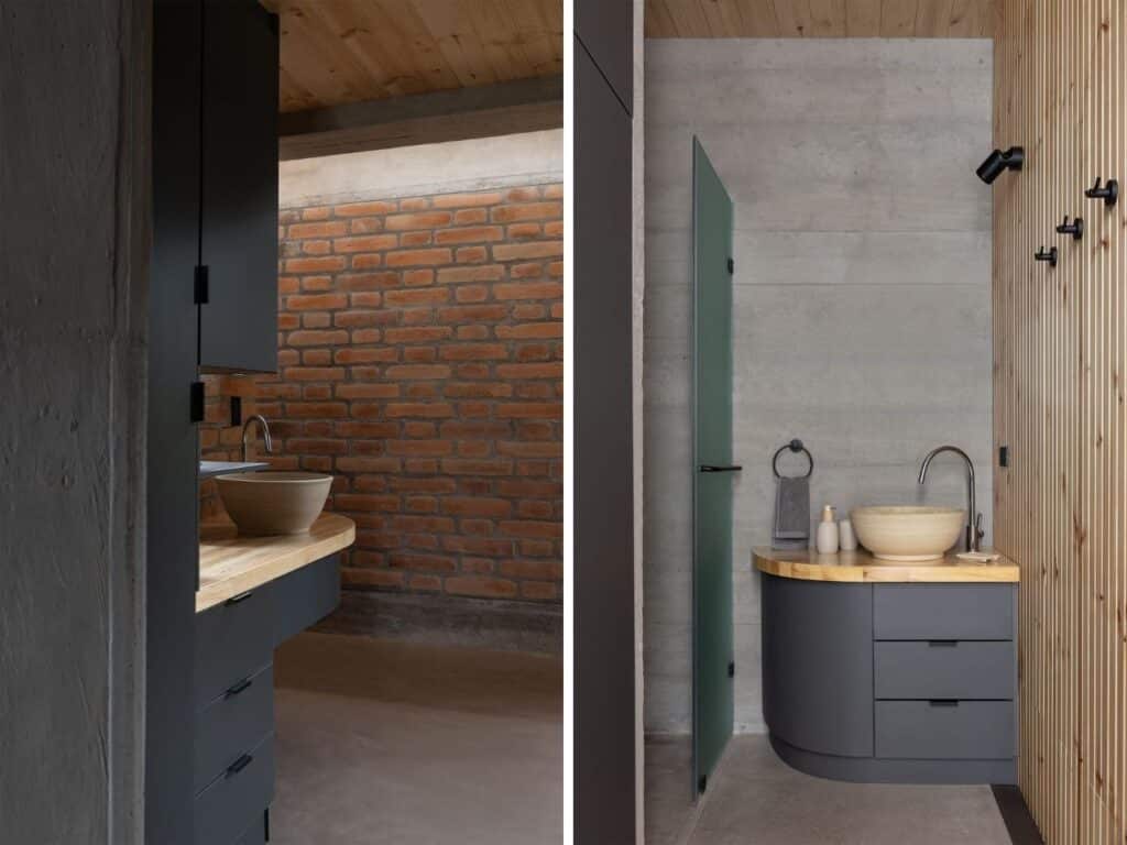 Interior view of a bathroom in La Miradora featuring exposed concrete walls, a wooden vanity, and a ceramic bowl sink.