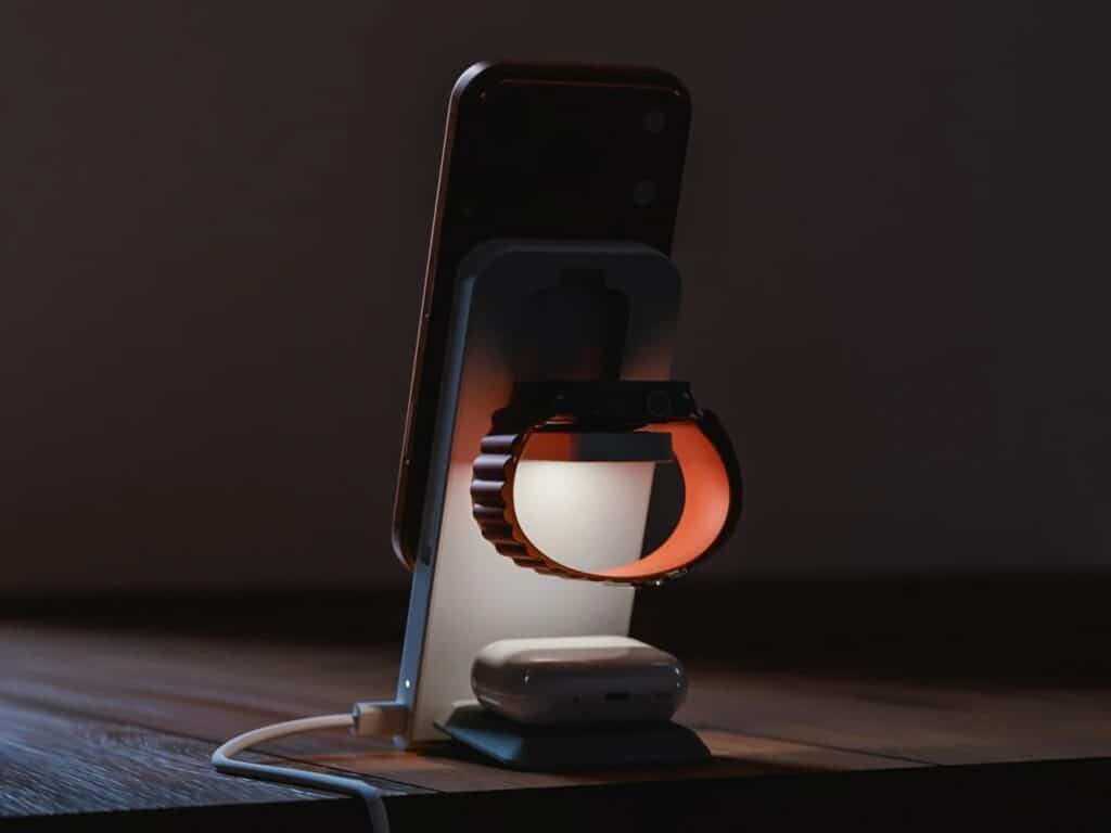Rear view of ARIA station in a dark room, highlighting the warm glow of the built-in LED ambient light behind the Apple Watch charger.