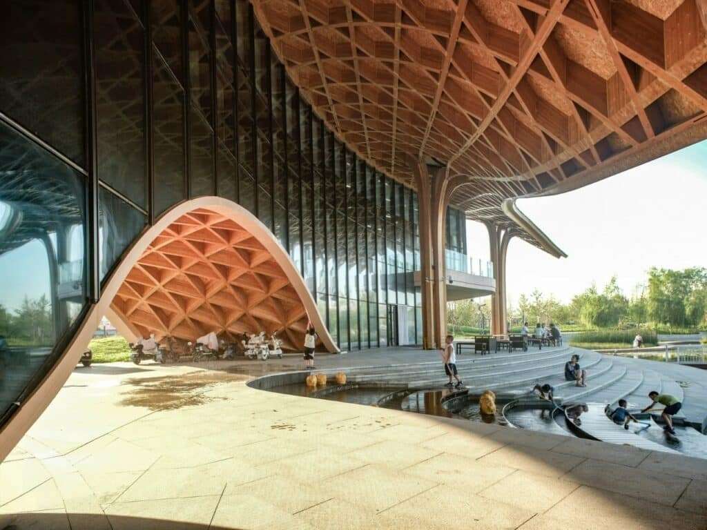 People enjoying the outdoor tiered seating and water features at the base of the restaurant.