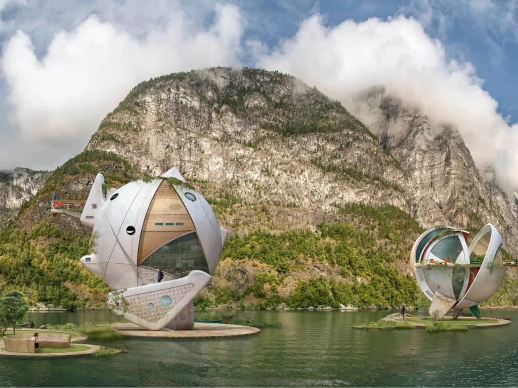 Two distinct spherical cabins on floating platforms in a fjord, illustrating architectural variation within a theme.