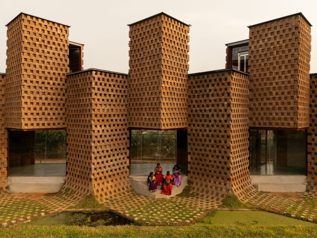Group of people sitting at the entrance of a shipping container module at Petti Restaurant.