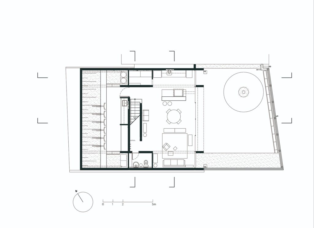 Architectural floor plan of the lower level of Caet&eacute;s House showing the kitchen, living, and garden layout.