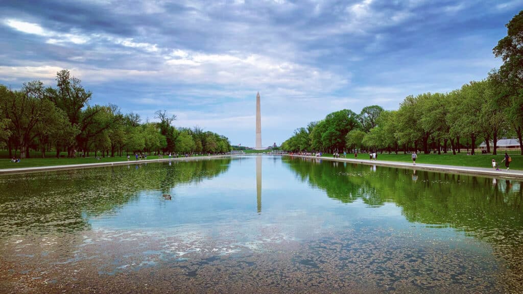 Lincoln Reflecting Pool with Washington Monument reflection and surrounding trees on the National Mall