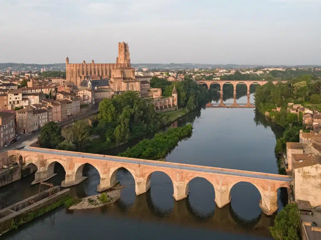 Close-up of custom cantilever supports attaching a metal walkway to a historic brick viaduct pier.