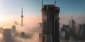 SkyTower Toronto under construction aerial view showing 12-sided tapered form above city