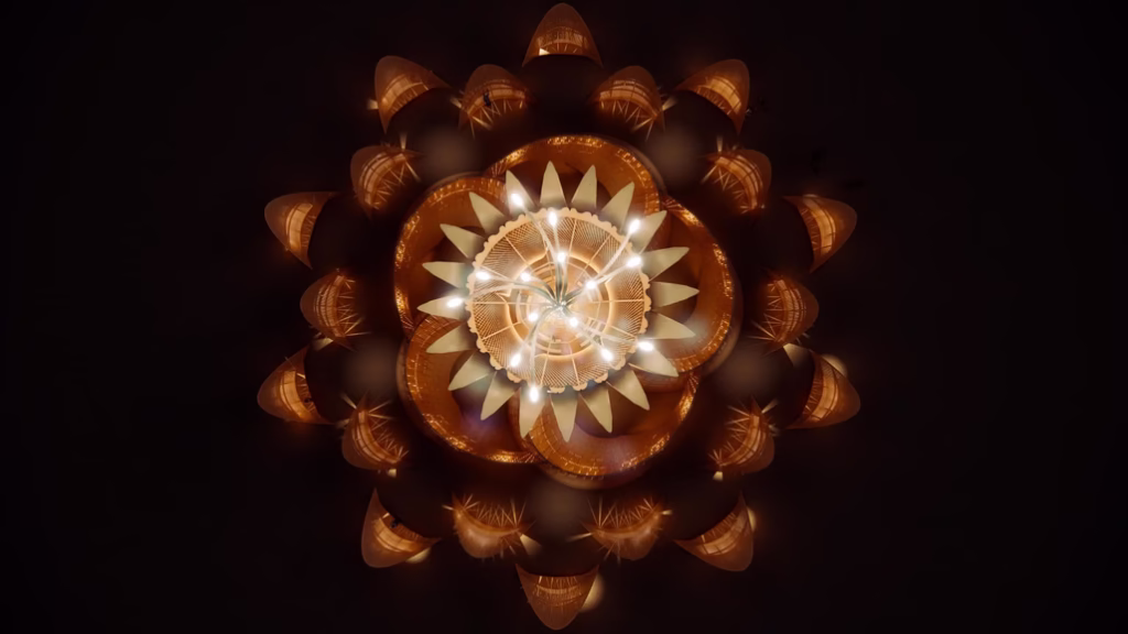 Aerial view of Temple of the Moon at Burning Man 2026 showing flower-shaped illuminated wooden structure at night