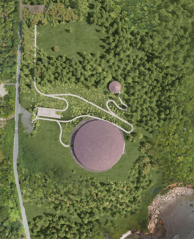 Top-down aerial view of the Sea of Time Museum circular structure and surrounding forested landscape near the cliff.