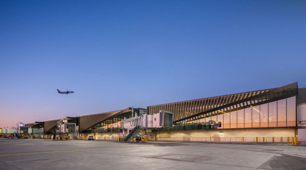 LAX Terminal concourse exterior with aircraft gates at dusk