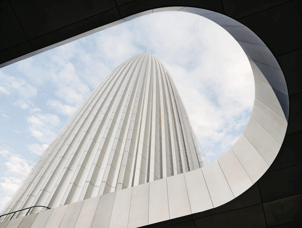 Mohammed VI Tower full exterior view at dusk showing the 250m skyscraper above its elliptical podium in Rabat Morocco