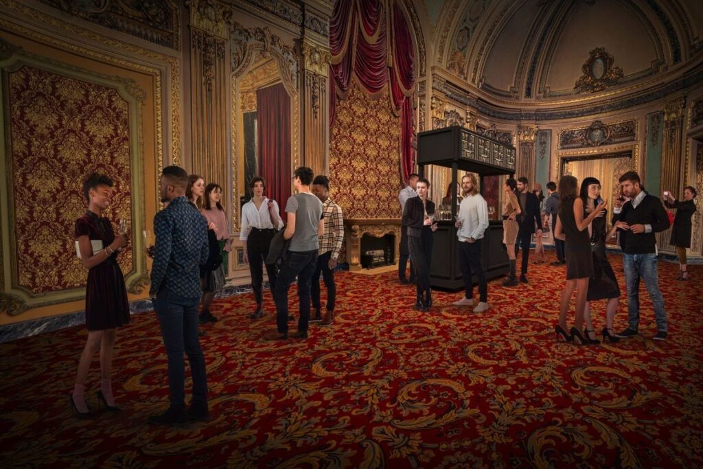 Exterior rendering of the restored Loews Theater in Jersey City at night, with a new "Grand Re-Opening" marquee.
