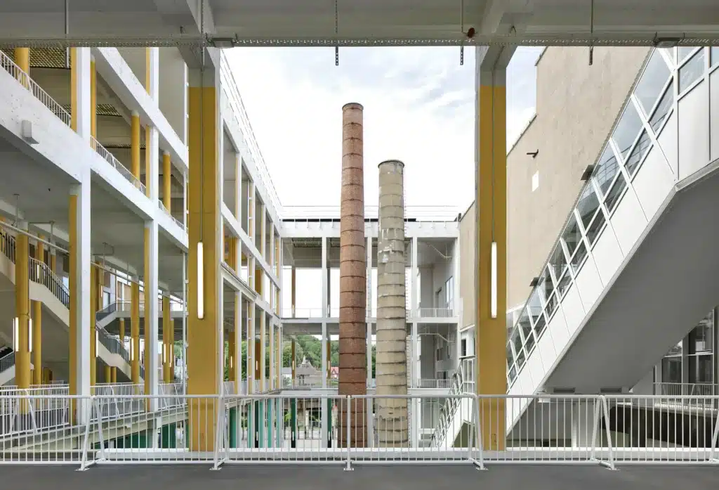 Preserved industrial chimneys inside Charleroi Palais des Expositions central atrium renewal