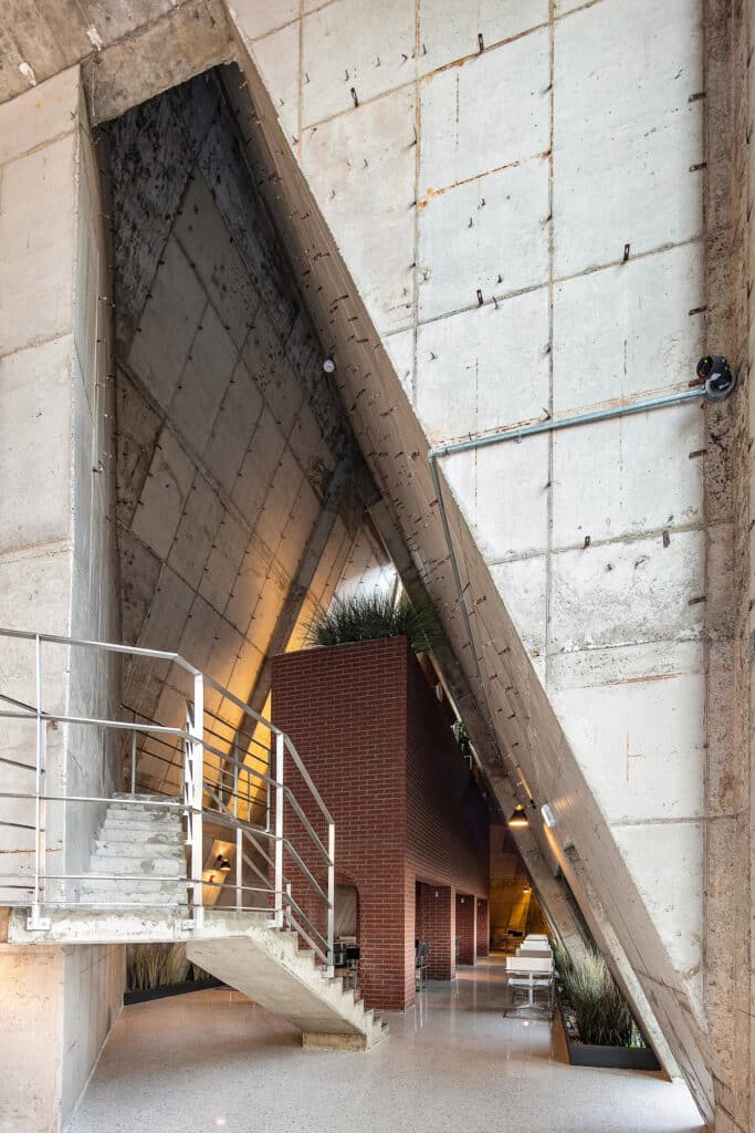 Abogoga cafe exposed concrete interior with brick volume and staircase