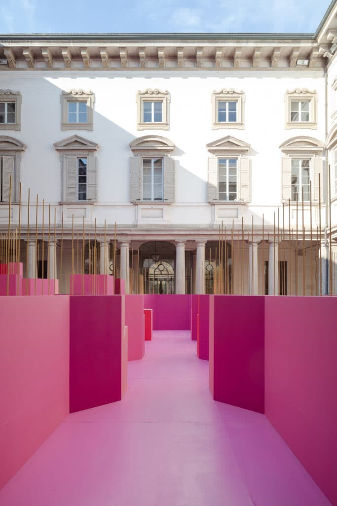Pink corridors of a wooden installation under natural light in Milan