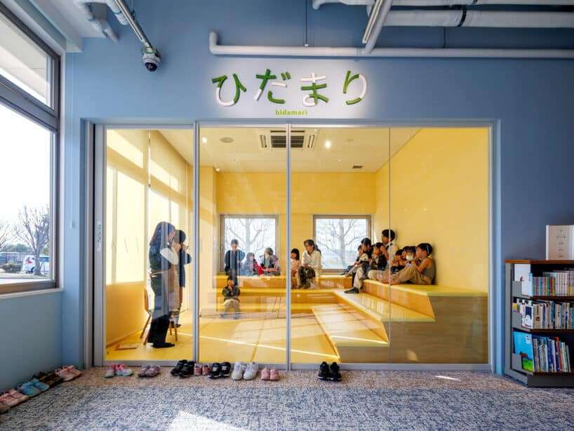 Central atrium with timber structural elements, staircase, and open reading areas inside Tsuki no Mori Library