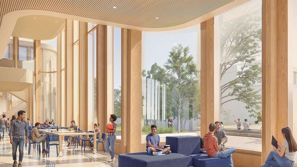 Night view of the stepped Temerty Building labs with autumn landscaping.