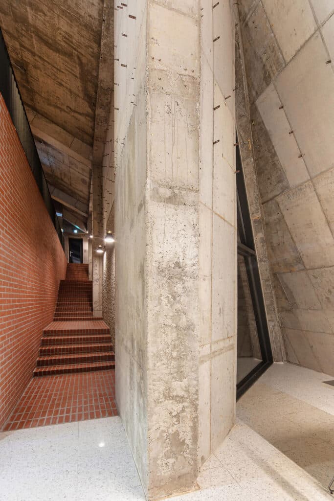 Brick staircase and raw concrete walls inside Abogoga cafe Gimpo