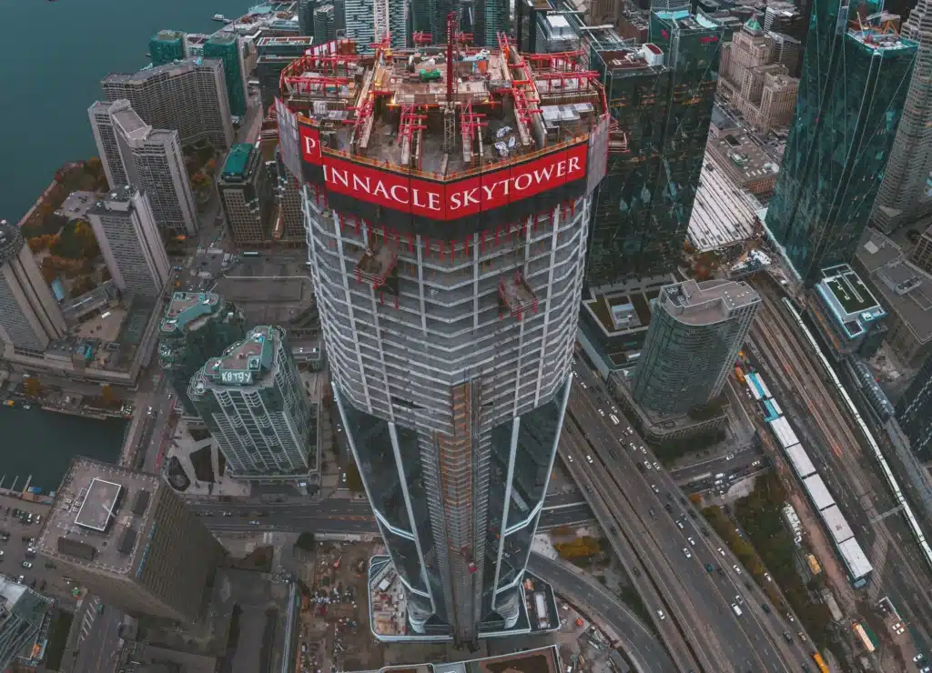 
SkyTower Toronto rising above fog with CN Tower visible skyline construction site