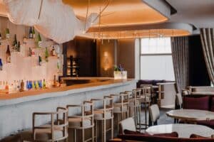 Nobu Hotel Warsaw Sake Bar interior featuring minimalist Japanese-inspired design with refined materials and ambient lighting.