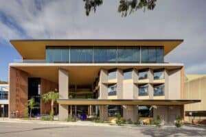 Exterior view of the Gosford Regional Library building showing the cantilevered roof, glass facade, and the public entrance at Kibble Park.