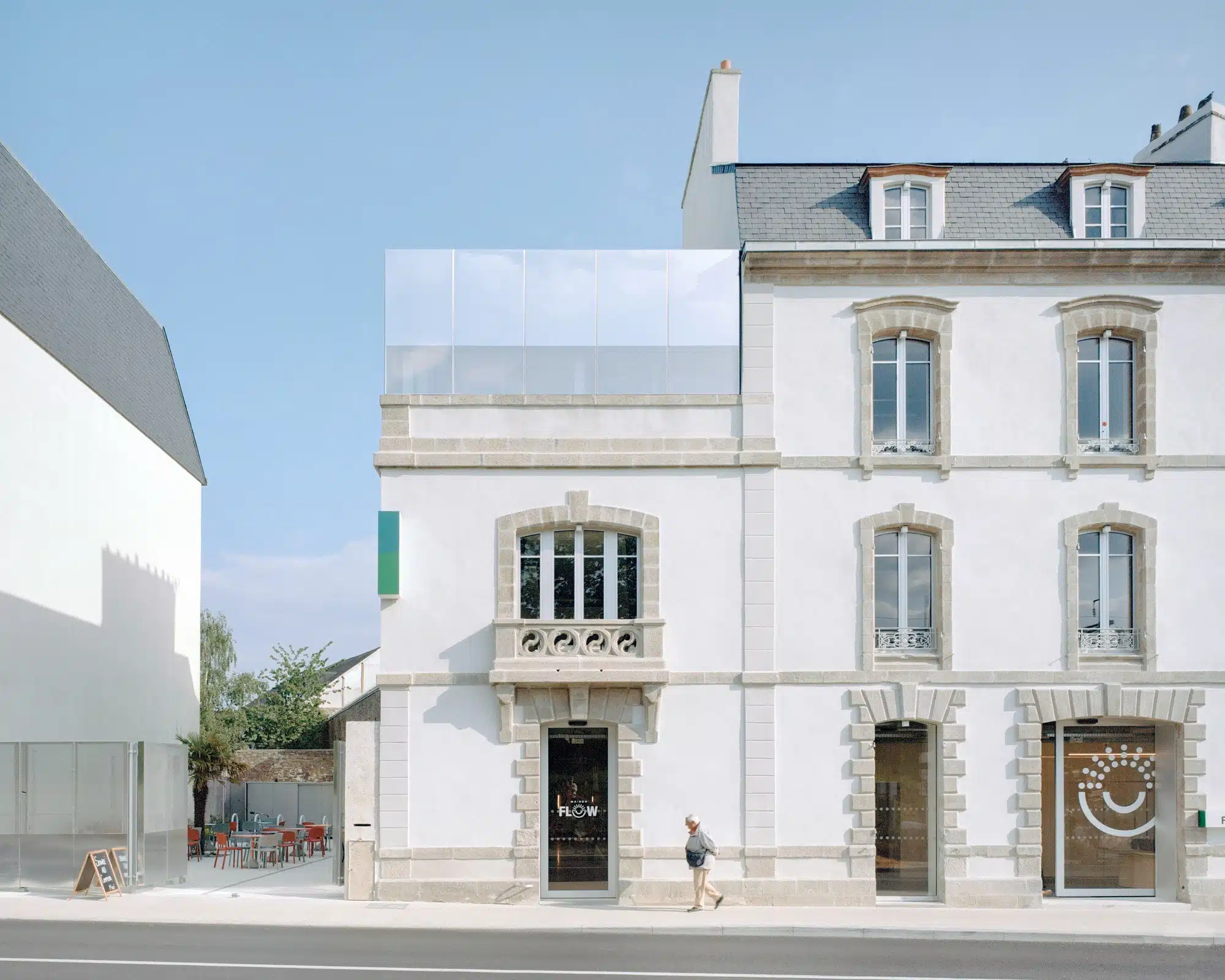 External facade of the renovated 19th-century industrial building near Vannes station, showing the blend of historic stone and modern aluminum extensions.