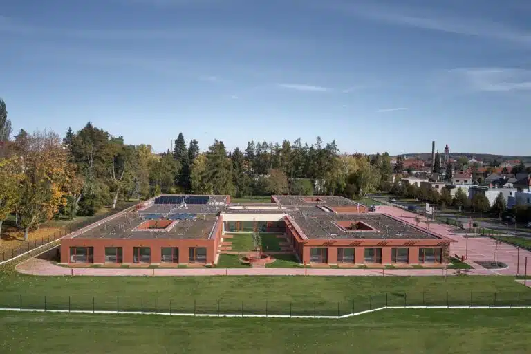 Aerial wide shot of the Senior Citizens Home in Novy Bydzov showing the four interconnected residential units and central courtyards.