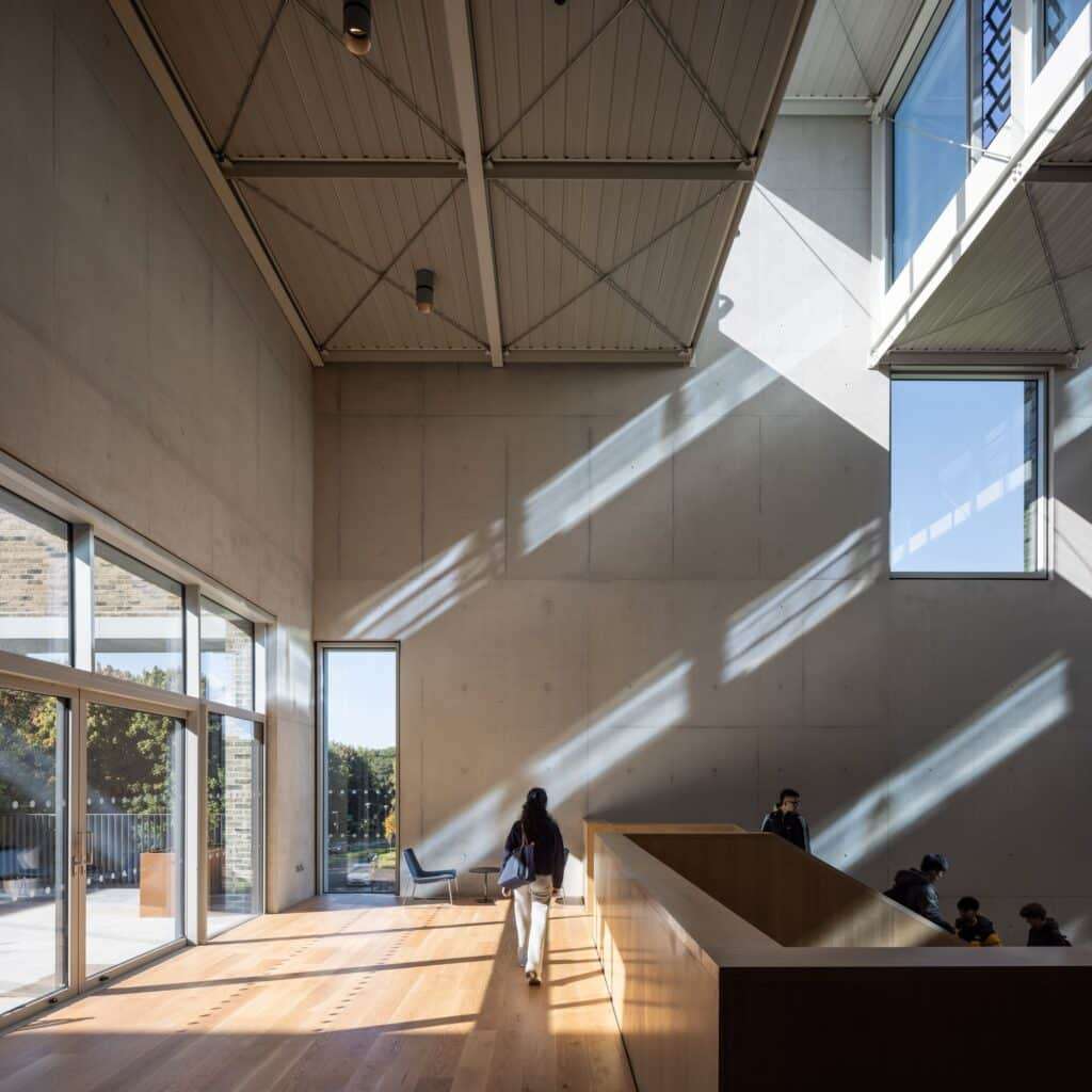 Interior atrium of the UL Student Centre showing high concrete walls and natural light streaming from automated roof glazing.