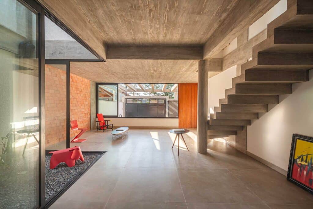 Open plan ground floor showing the integration of the staircase, courtyard, and living area.