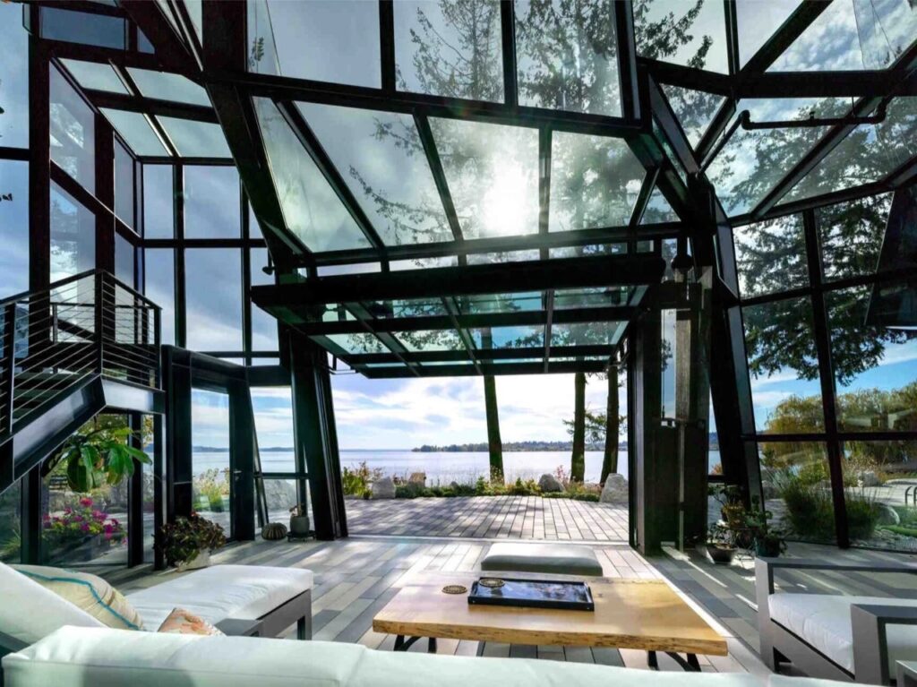 Interior view of F-House living area showing complex steel structure and faceted glass roof overlooking Lake Washington.