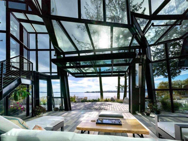 Interior view of F-House living area showing complex steel structure and faceted glass roof overlooking Lake Washington.