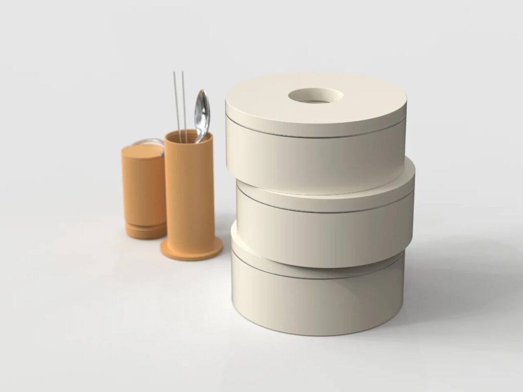 Vertical stack of three Ring Lunch Box containers next to the cylindrical utensil holder.