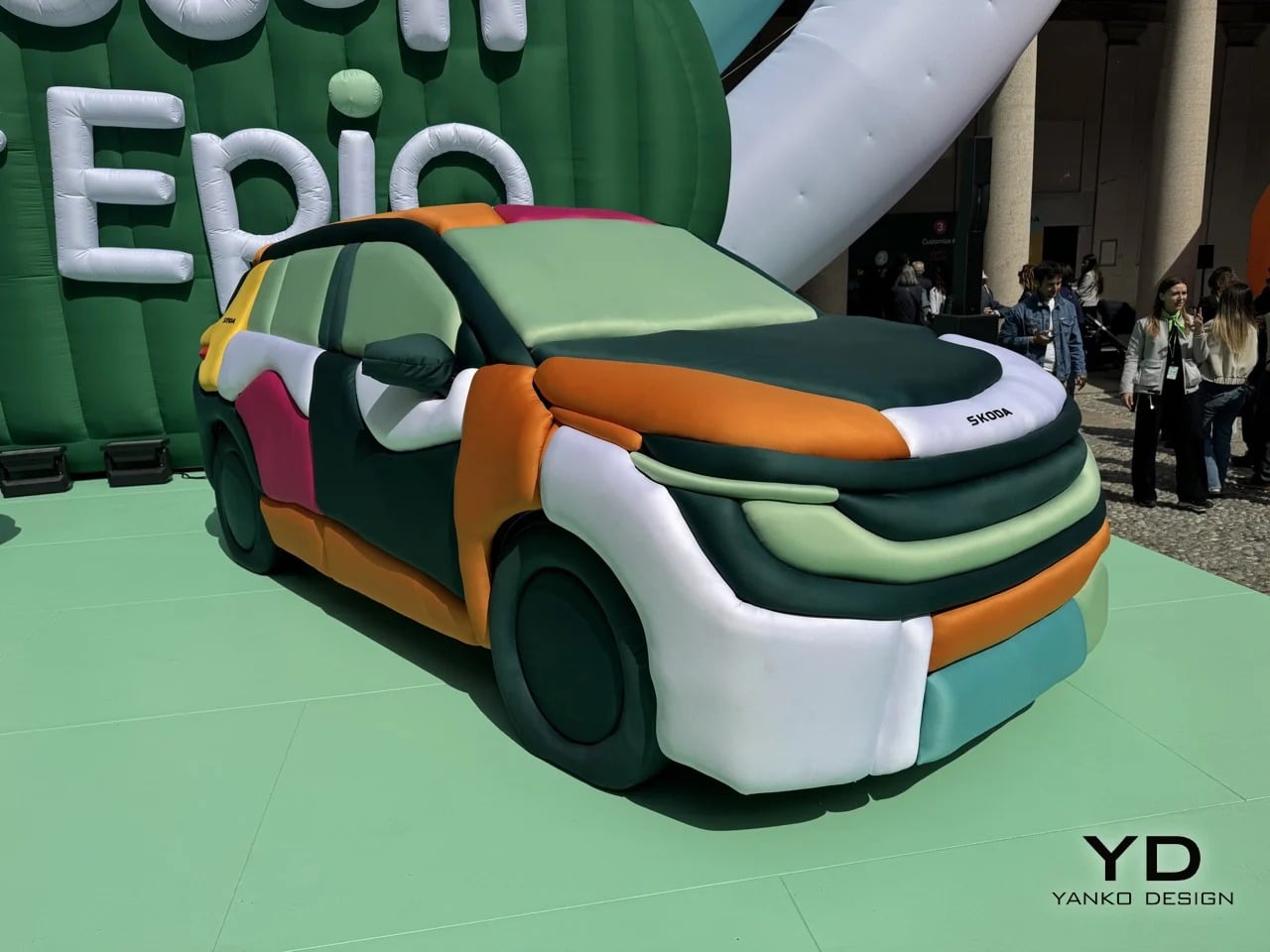 Three-quarter front view of the Skoda Epiq electric car covered in colorful inflatable textile panels at Milan Design Week.